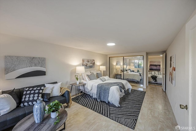 bedroom featuring light wood-type flooring and a closet