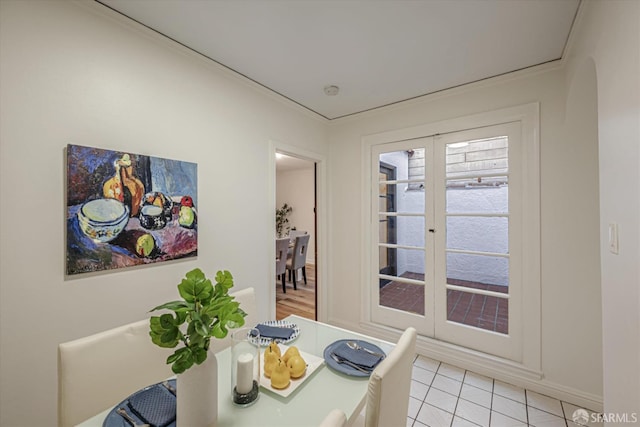 tiled dining space featuring french doors