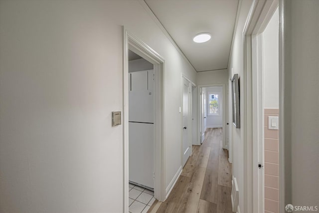 corridor with light hardwood / wood-style flooring