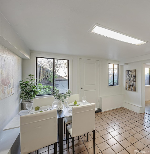 tiled dining room featuring a wealth of natural light