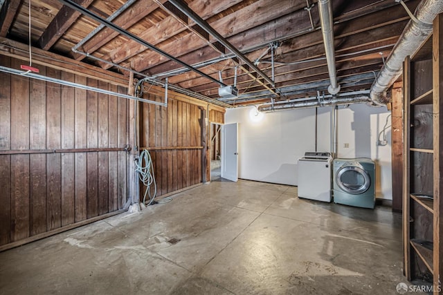 basement featuring independent washer and dryer and wooden walls