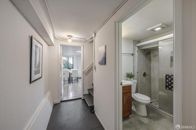 bathroom with toilet, an enclosed shower, and vanity