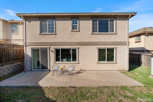 rear view of property featuring a patio