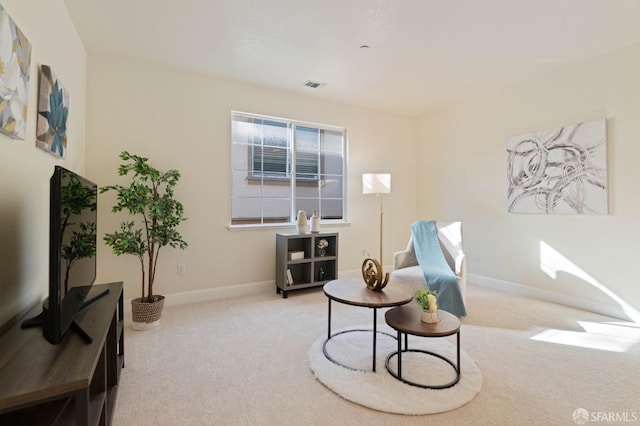 living area with light carpet