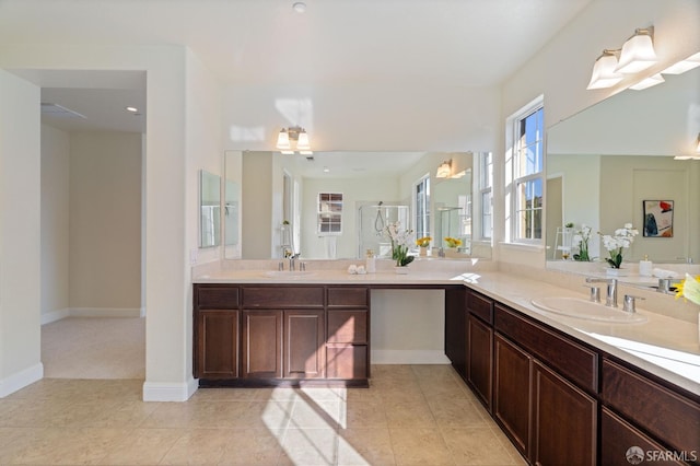 bathroom featuring tile patterned floors, a shower with shower door, and vanity