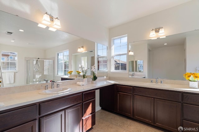 bathroom featuring tile patterned flooring, vanity, and a shower with shower door