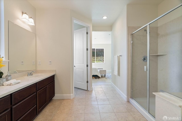 bathroom with vanity, a shower with door, and tile patterned floors