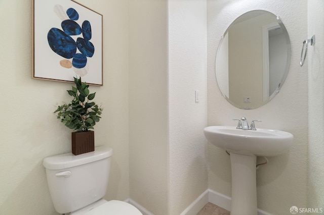 bathroom featuring toilet and sink