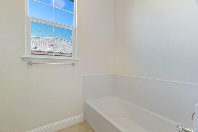 bathroom featuring tile patterned floors and a washtub