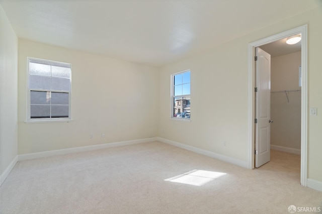 spare room featuring light colored carpet