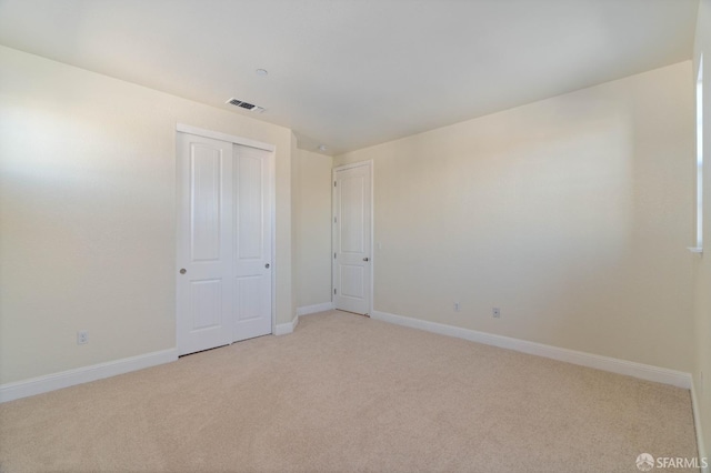 spare room featuring light colored carpet