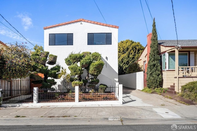 view of front of property with a fenced front yard and stucco siding