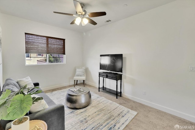 living room with light colored carpet and ceiling fan