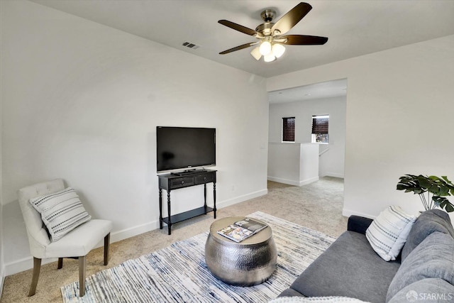 carpeted living room with ceiling fan