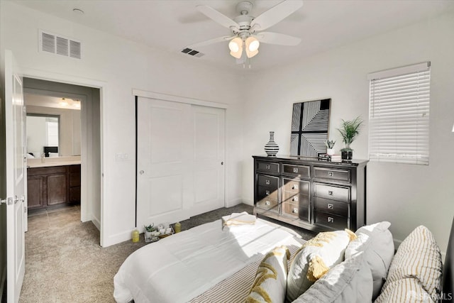 bedroom with ceiling fan, a closet, and light carpet