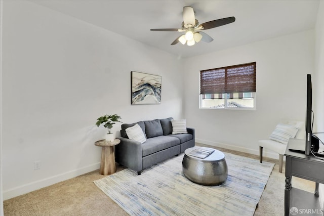 carpeted living room with ceiling fan