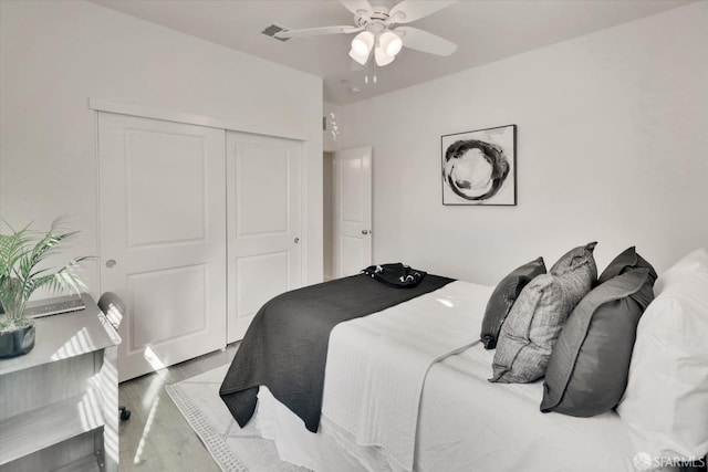 bedroom featuring a closet, ceiling fan, and light wood-type flooring