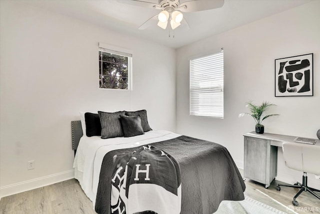 bedroom with ceiling fan and light hardwood / wood-style floors