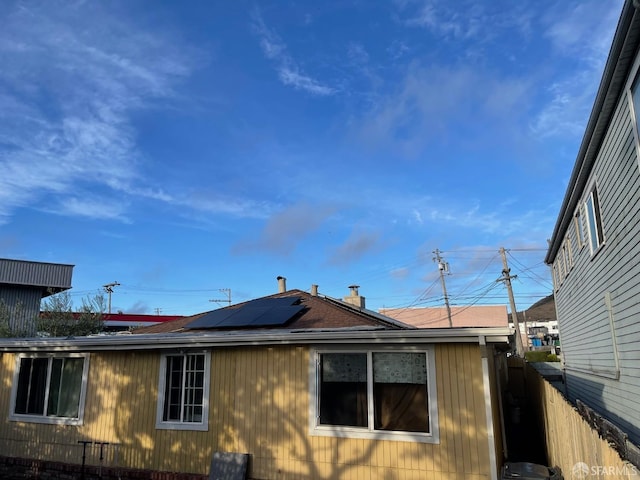 view of side of home featuring solar panels