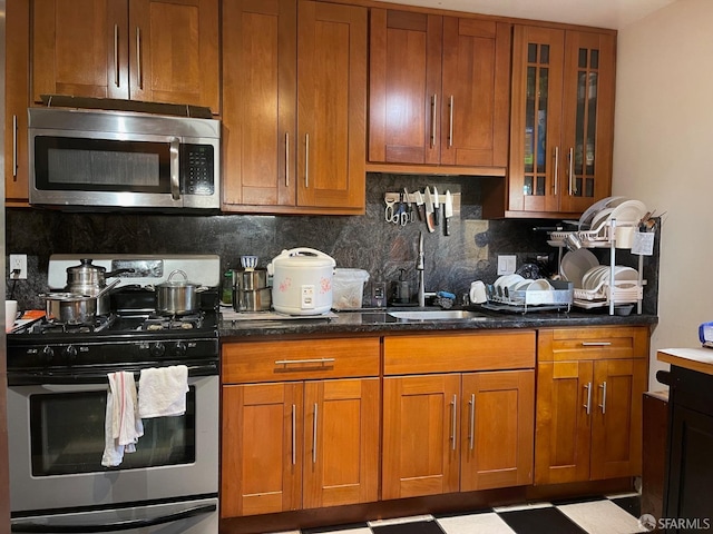 kitchen featuring decorative backsplash, sink, and appliances with stainless steel finishes