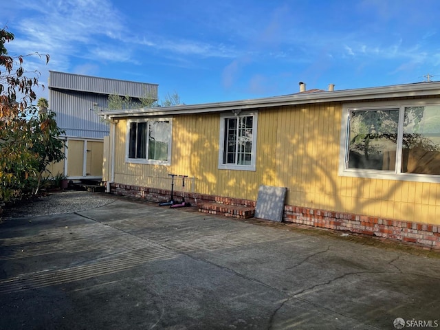 view of side of property featuring a patio area