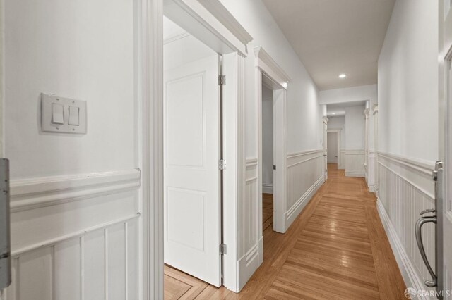 hallway with light hardwood / wood-style flooring