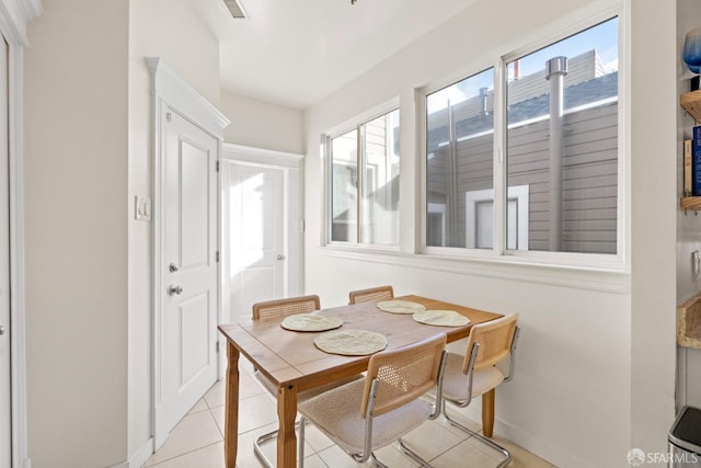 dining area with light tile patterned floors