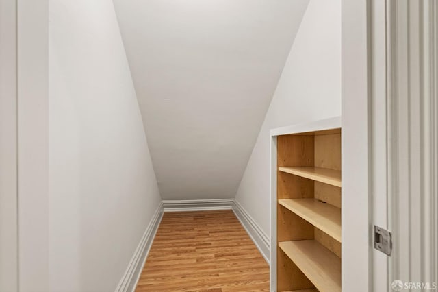 interior space featuring light hardwood / wood-style floors and lofted ceiling