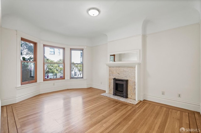 unfurnished living room with a fireplace and light hardwood / wood-style flooring