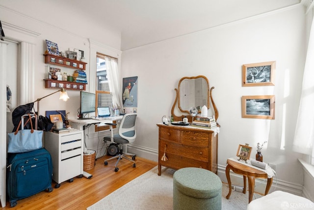 home office with light hardwood / wood-style flooring