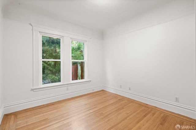 unfurnished room featuring hardwood / wood-style flooring