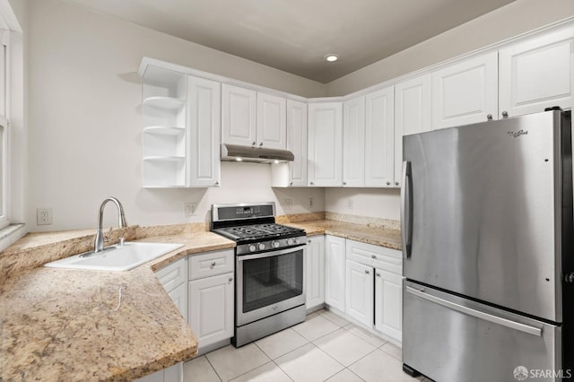 kitchen with sink, kitchen peninsula, light stone counters, white cabinetry, and stainless steel appliances