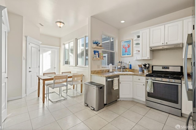 kitchen featuring white cabinets, light tile patterned flooring, sink, and appliances with stainless steel finishes