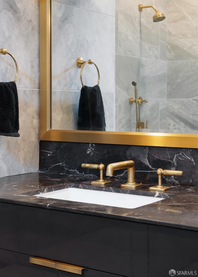 bathroom with tasteful backsplash and vanity