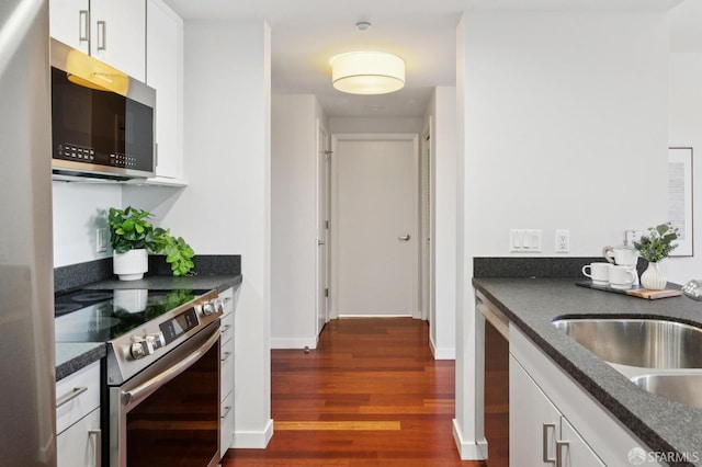 451 Kansas St Unit 428, San Francisco, CA 94107 - kitchen featuring stainless steel appliances, dark wood finished floors, and white cabinetry