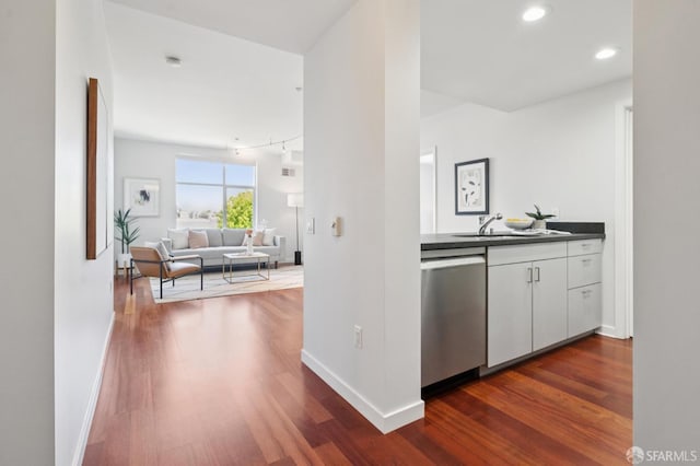 451 Kansas St Unit 428, San Francisco, CA 94107 - kitchen featuring stainless steel dishwasher, dark wood-type flooring, dark countertops, white cabinetry, and recessed lighting
