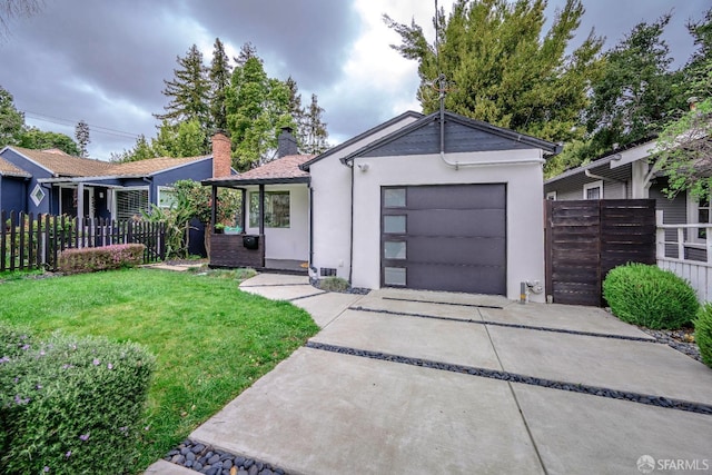 single story home featuring stucco siding, an attached garage, fence, driveway, and a front lawn