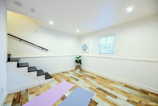 exercise room with recessed lighting, baseboards, and wood finished floors