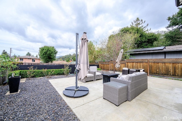 view of patio with a fenced backyard and an outdoor living space with a fire pit