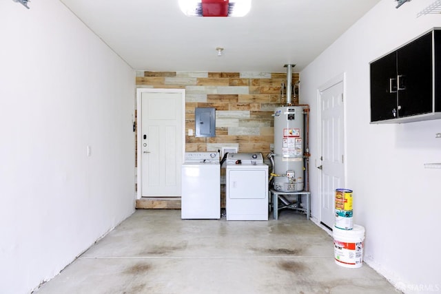 garage featuring gas water heater, an accent wall, wood walls, independent washer and dryer, and electric panel