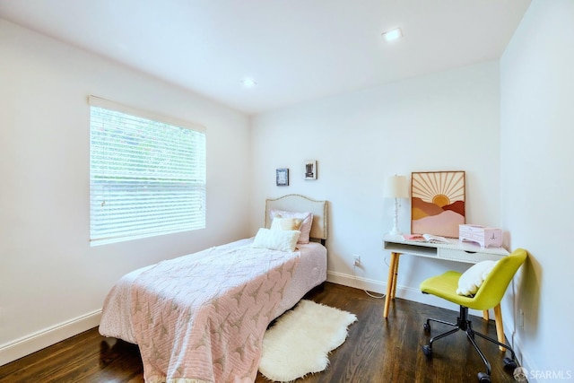 bedroom featuring baseboards and wood finished floors