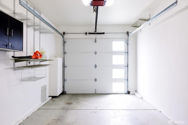 garage featuring visible vents and a garage door opener