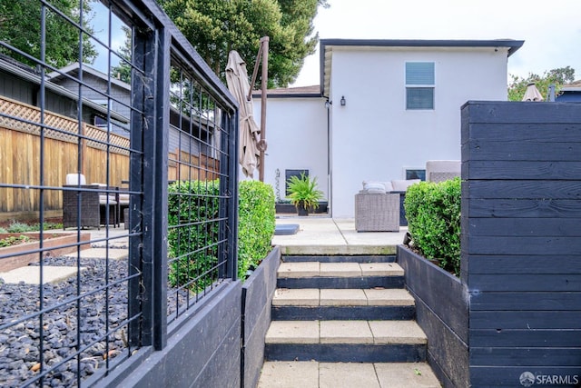 view of gate featuring a patio area and fence