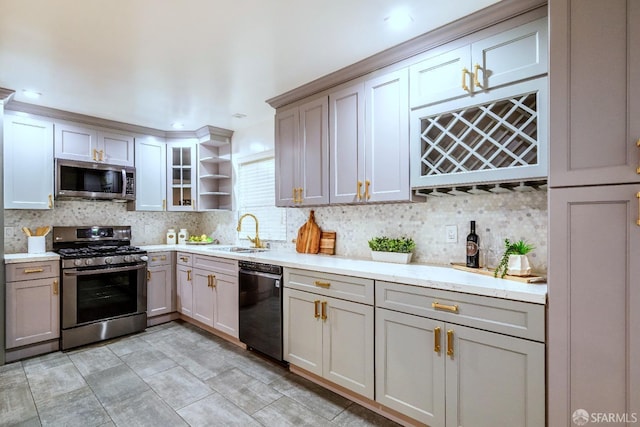 kitchen featuring appliances with stainless steel finishes, tasteful backsplash, a sink, and open shelves