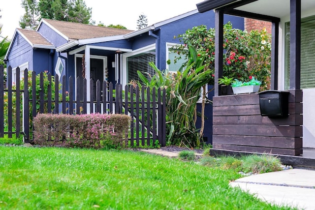 view of side of home featuring a yard and fence