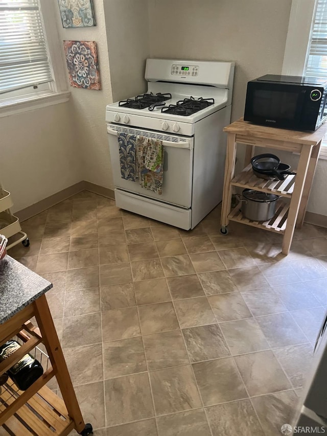 kitchen featuring white range with gas stovetop