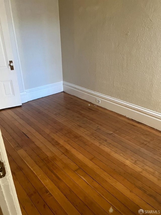 spare room featuring dark hardwood / wood-style flooring