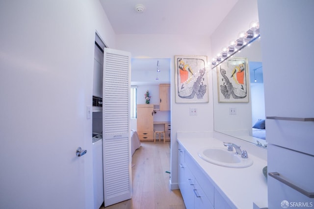 bathroom with hardwood / wood-style floors and vanity