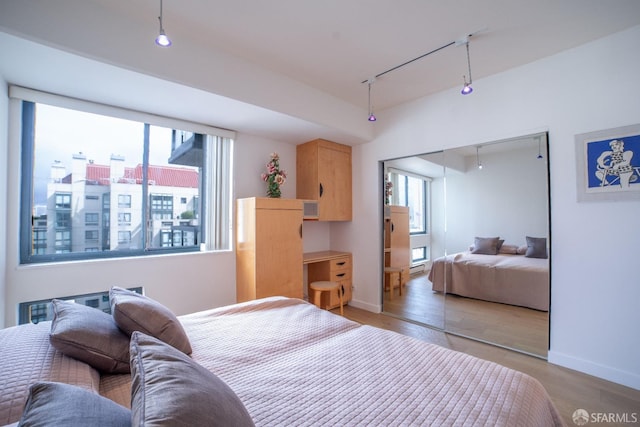 bedroom with light wood-type flooring and a closet