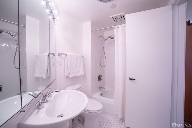 full bathroom with tile patterned flooring, shower / bath combo, toilet, and sink